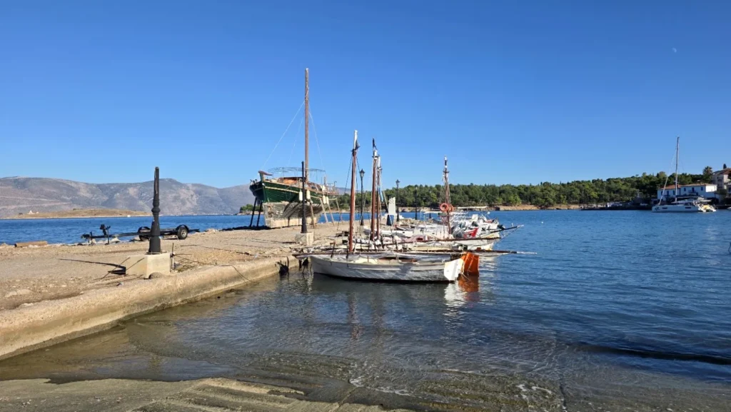 Traditional wooden boats moored beside Chirolakas harbour