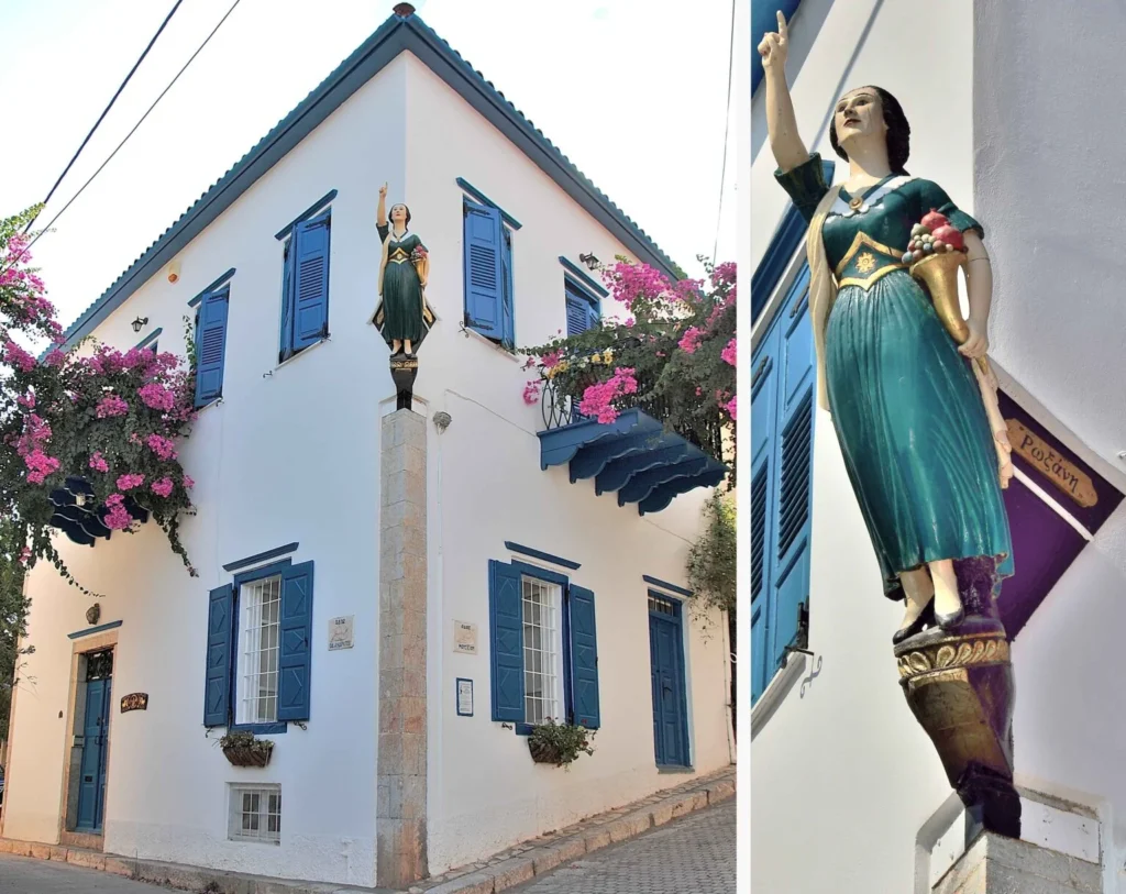 Roxani mansion with blue shutters, bougainvillea and a carved ship's figurehead