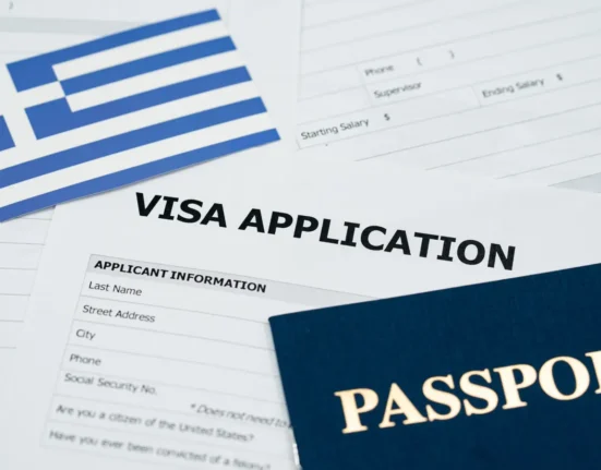 Greek flag, passport and visa application documents for moving to Greece
