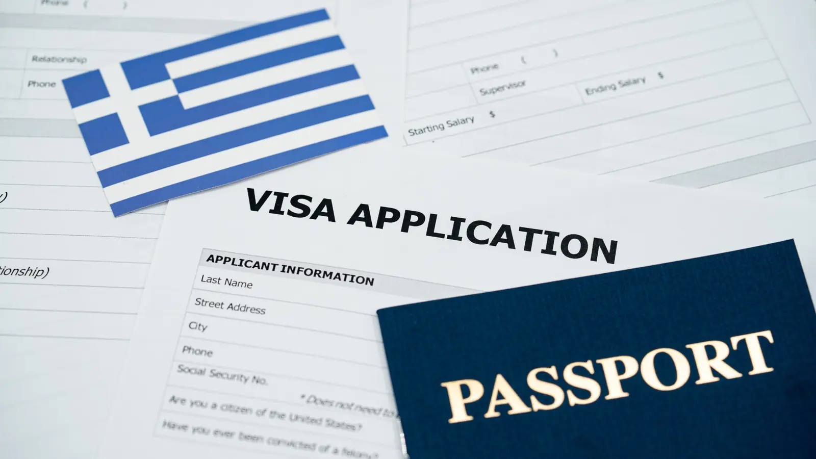 Greek flag, passport and visa application documents for moving to Greece