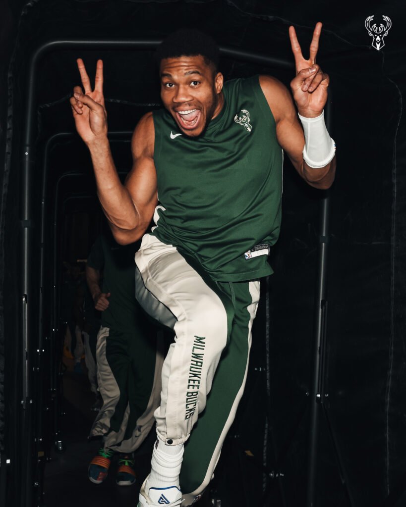 Gree NBA Star Giannis-Antetokounmpo makes vicory sign. An example of non-verbal communication