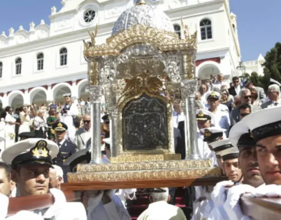 Hellenic Navy officers carry the holy icon of the Virgin Mary during the August 15 procession in Tinos