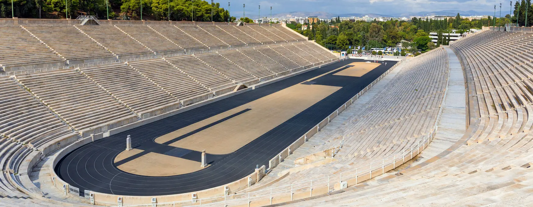 The Panathenaic Stadium, or Kallimármaro, is a historic marble stadium in Athens, hosting the first modern Olympics in 1896. Reconstructed from an ancient site, it remains the world's only stadium made entirely of marble. Credit: visitgreece.gr