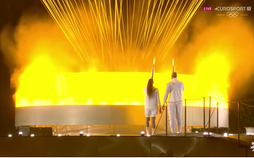 Final torchbearers Marie-José Pérec and Teddy Riner stand before the Olympic cauldron, poised to rise attached to a balloon, after a relay of 11,000 torchbearers, during the Paris 2024 Olympic opening ceremony at the Jardin des Tuileries on July 26.