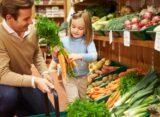 father and daughter buying veggies