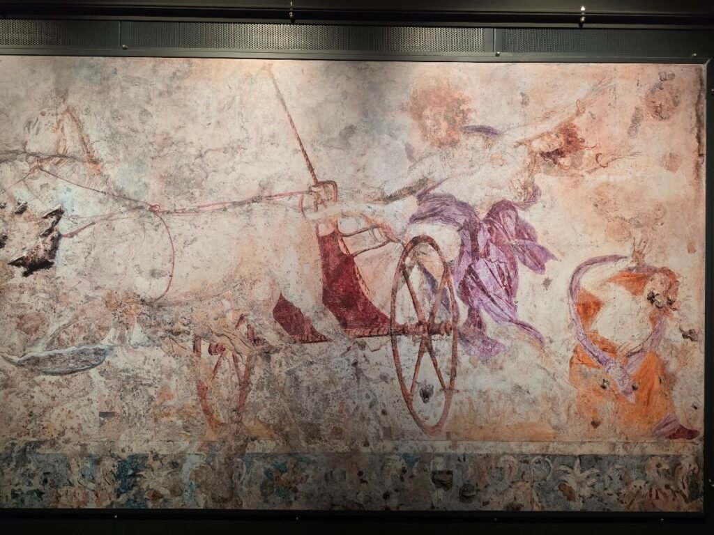 Close-up of the north wall fresco from Tomb I (Tomb of Persephone) showing Hades abducting Persephone, her flowing blond hair and crimson garment, and the distressed friend behind the chariot. Museum of the Royal Tombs of Aigai, Expats Athens, Expats Greece, Xpat.gr