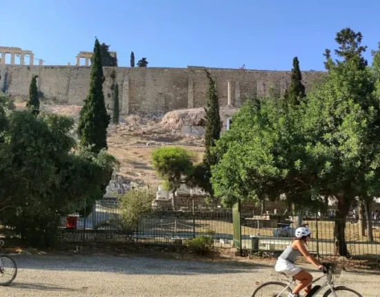 Cyclists below the Acropolis in Athens, Greece