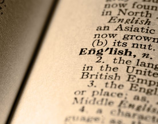 Close-up photograph of the word “English” on a vintage dictionary page, symbolising the history and evolution of the English language.