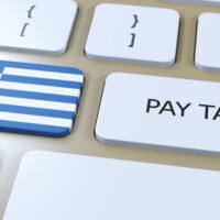 Keyboard with tax documents, representing Greek tax filing and financial planning for expats in Greece.