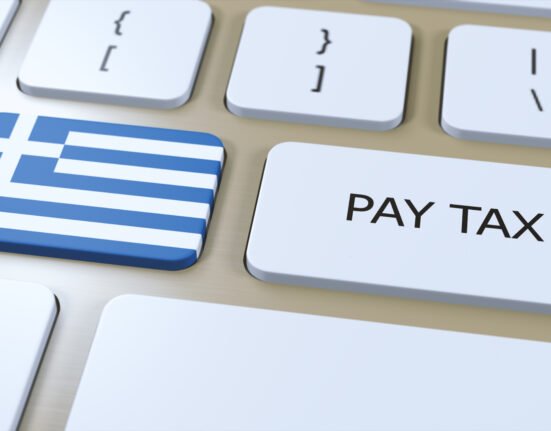 Keyboard with tax documents, representing Greek tax filing and financial planning for expats in Greece.