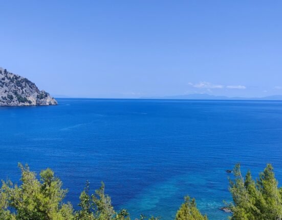 Evia Greece Evia, Greece. Deep blue water, clear sky and rocky coastline
