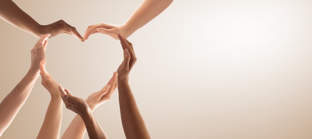 Symbol and shape of heart created from hands.