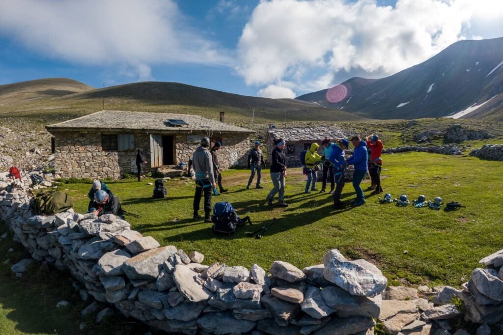 Hikers outside a mountain refuge on Mount Olympus during an Unlimited Adrenaline two-day ascent featured on Xpat.gr