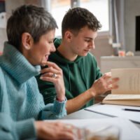Teenager studying with a private tutor in Greece, representing tutoring culture, international school pressure and university preparation.