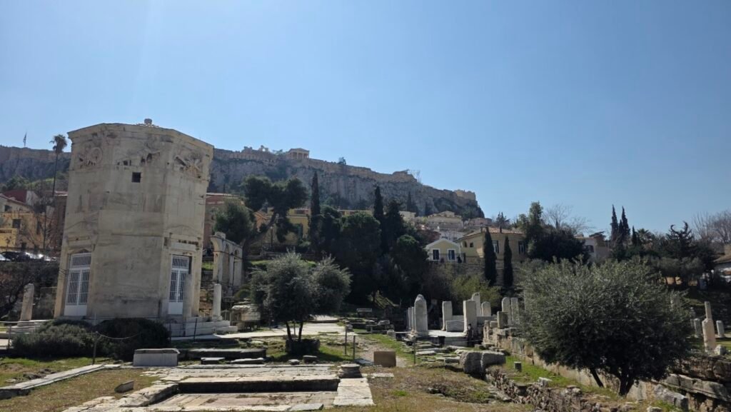 The Tower of the Winds in the Roman Agora of Athens with the Acropolis in the background.