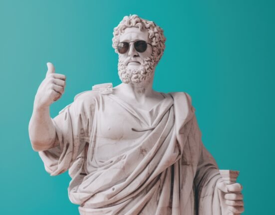 Ancient Greek philosopher statue wearing sunglasses, symbolising Greek culture and communication.