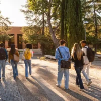 University students with backpacks walking together across a campus