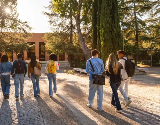 University students with backpacks walking together across a campus