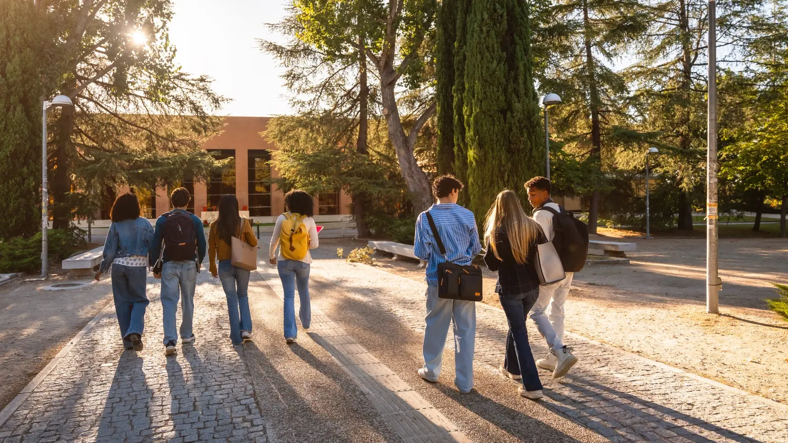 University students with backpacks walking together across a campus