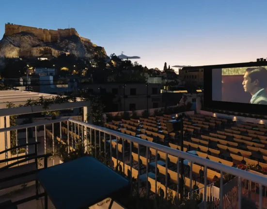 Cine Paris open-air cinema overlooking the illuminated Acropolis at dusk