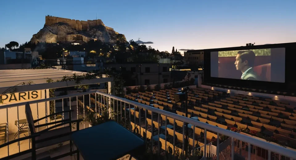 Cine Paris open-air cinema overlooking the illuminated Acropolis at dusk