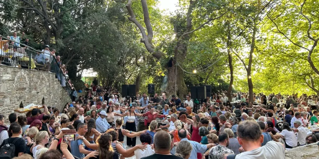 People dancing in a circle at a traditional village panigiri in Ikaria