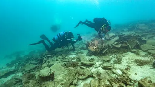 Divers examining the archaeological remains at Kikynthos