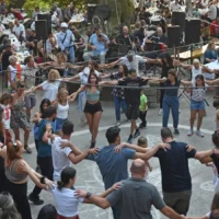 People dancing in a circle at a traditional village panigiri in Ikaria, Greece
