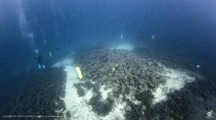 A diver exploring the amphora cargo at the Peristera shipwreck near Alonissos
