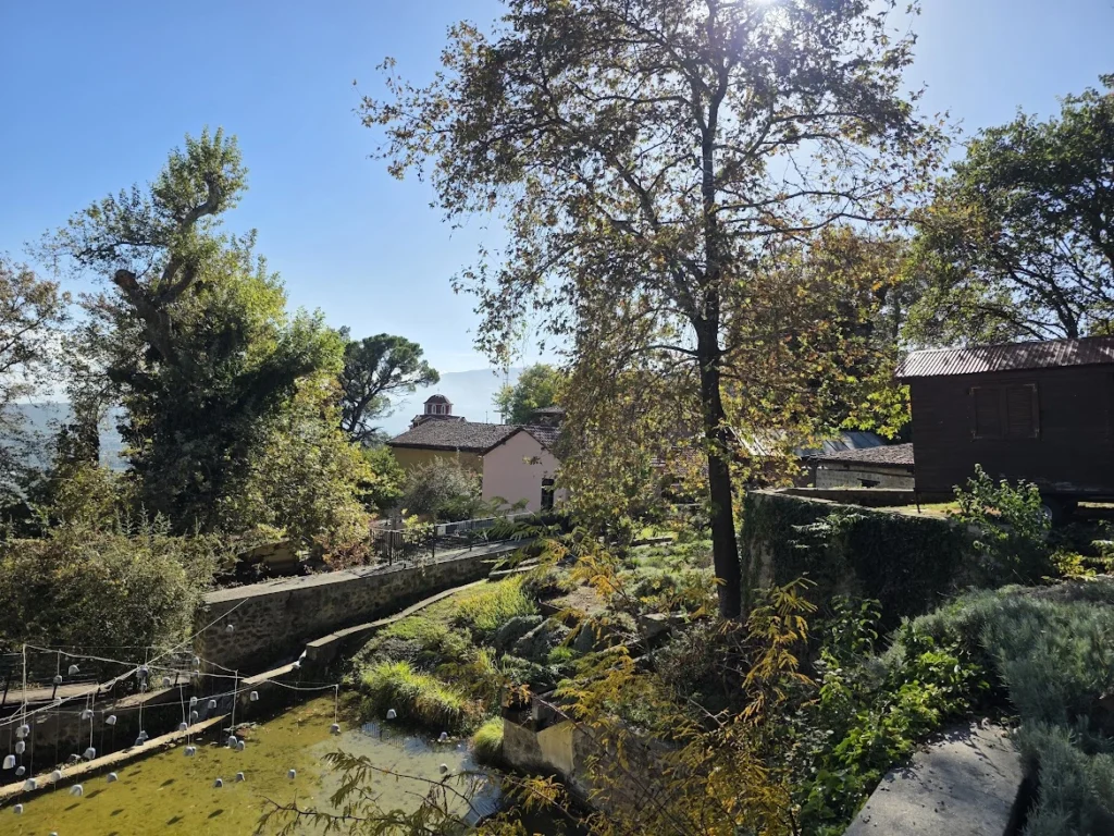 Restored mill building and historic water-powered machinery at the Open-Air Water Museum of Edessa