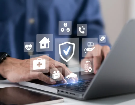 Insurance protection icons for health, home, car and financial cover displayed over a laptop screen