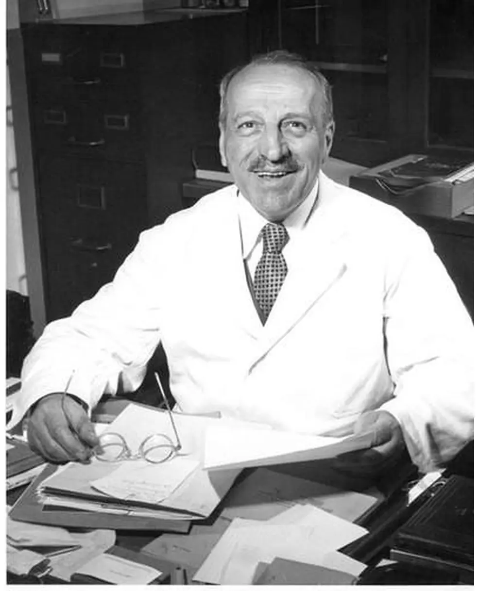 Georgios Papanikolaou seated at his desk in a laboratory coat at Cornell University Medical College.
