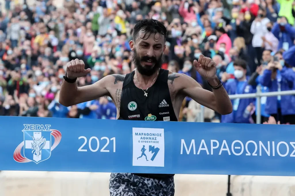 Kostas Gelaouzos crossing the finish line at the 2021 Athens Marathon.