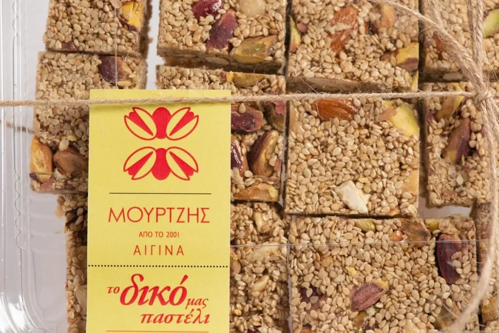 Packaged Mourtzis pasteli squares containing sesame seeds and pistachios.