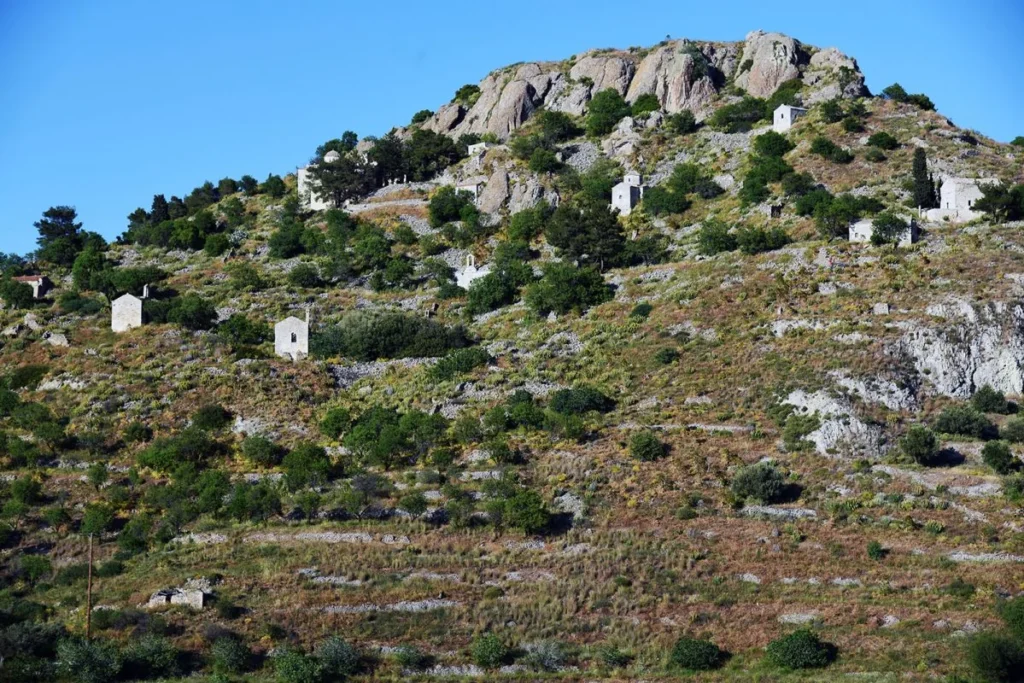 Small stone chapels scattered across the rocky hillside of Paleochora on Aegina.