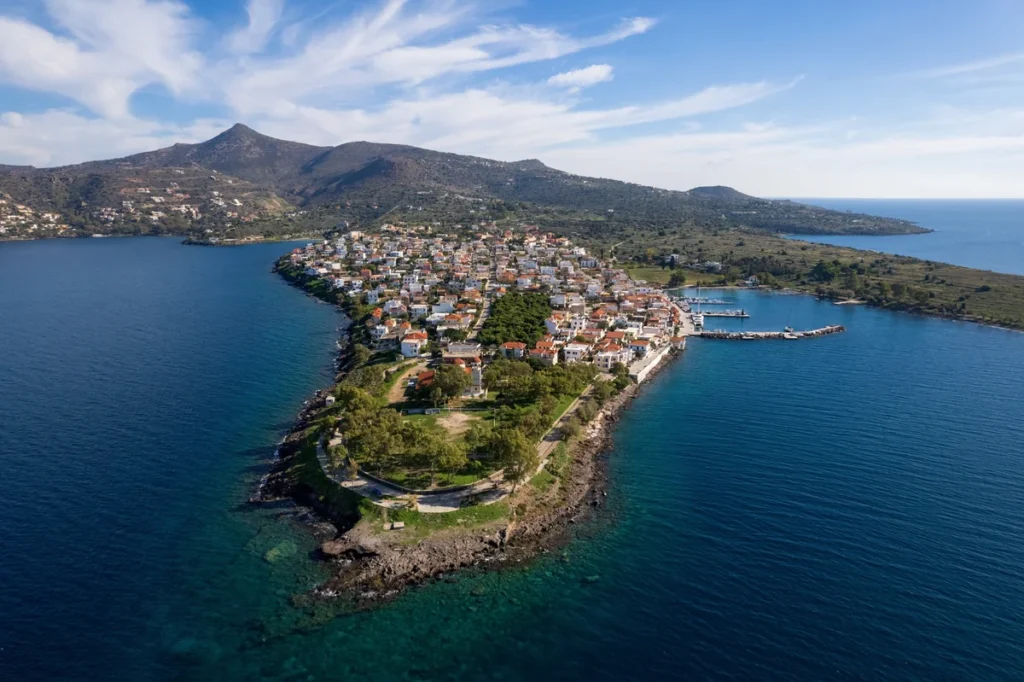 Aerial view of Perdika’s peninsula, white houses and harbour surrounded by the Saronic Gulf.