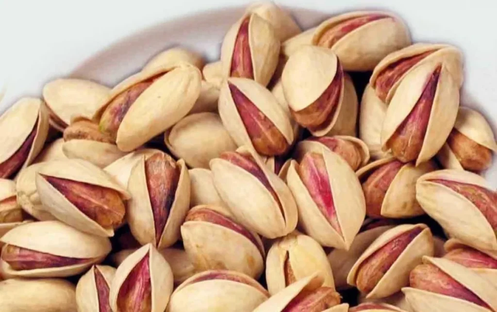 Split-shell pistachios with their kernels visible.