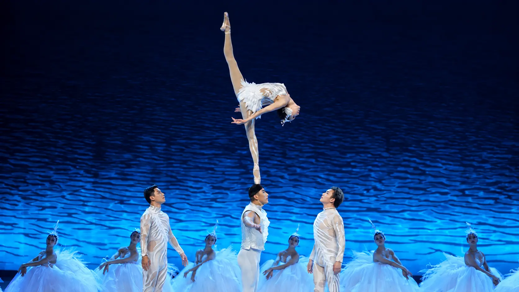 Female acrobat performing the Shoulder Ballet during the SWAN acrobatic dance drama.