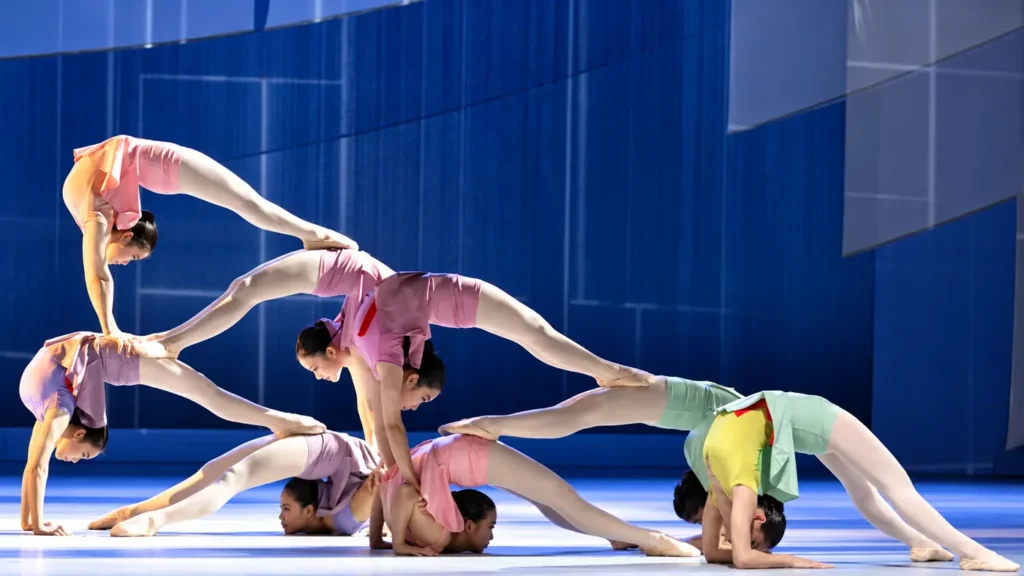 Acrobats form a connected sequence of balances during the SWAN acrobatic dance drama.