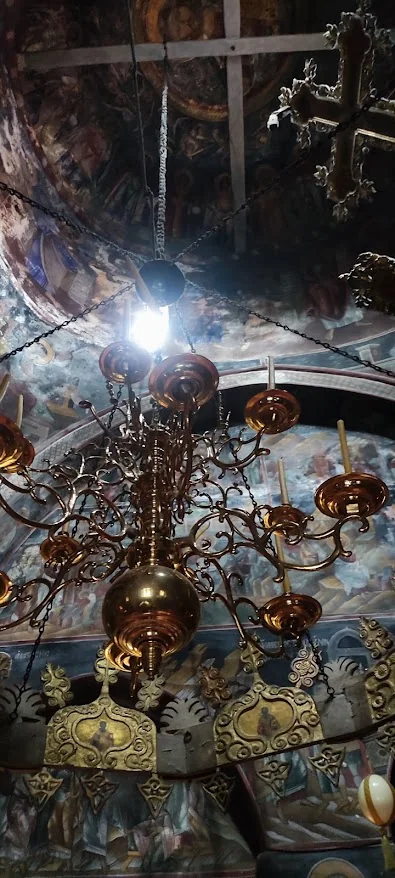 Frescoes and carved wooden chandelier inside the Monastery of Agios Georgios in Feneos