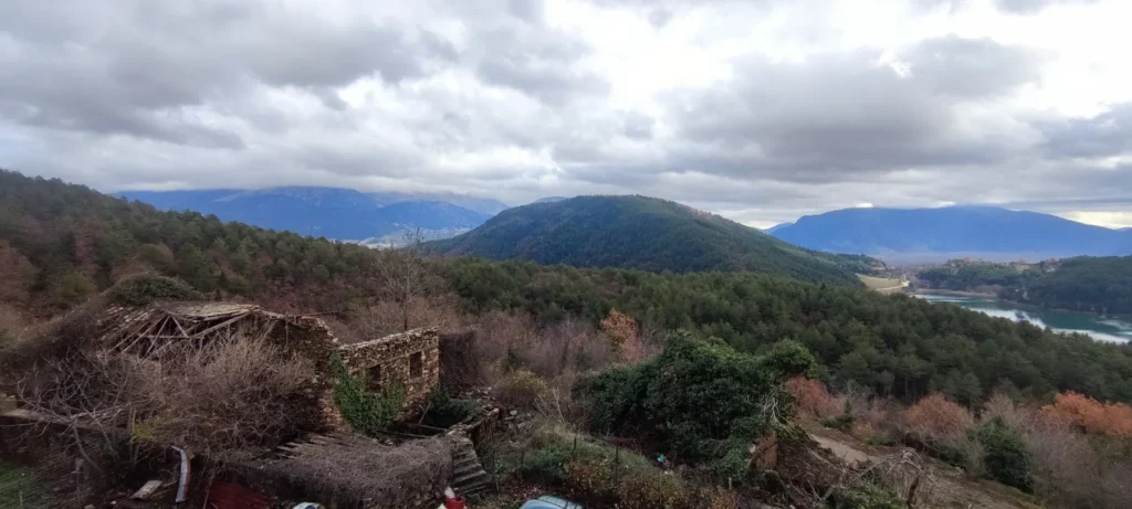 Old stone building on the hillside above Lake Doxa