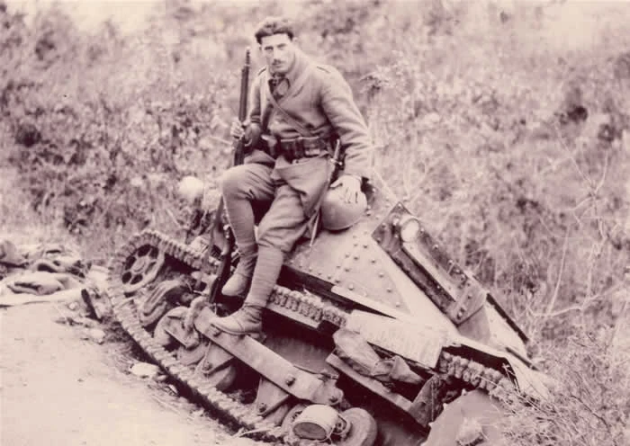Greek soldier seated on a captured Italian tankette at Kalpaki during the Greco-Italian War of 1940.